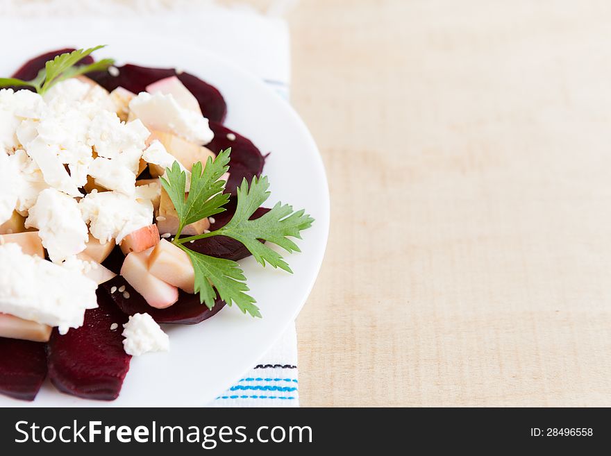 Salad with apples and beets on a plate