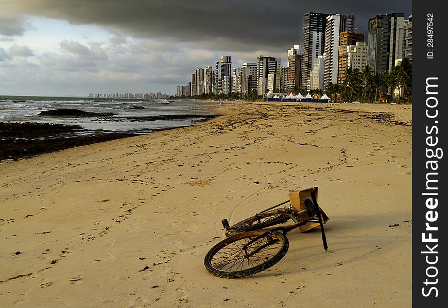 Bicycle lying on the sand of a beautiful beach in Recife, Brazil. Bicycle lying on the sand of a beautiful beach in Recife, Brazil