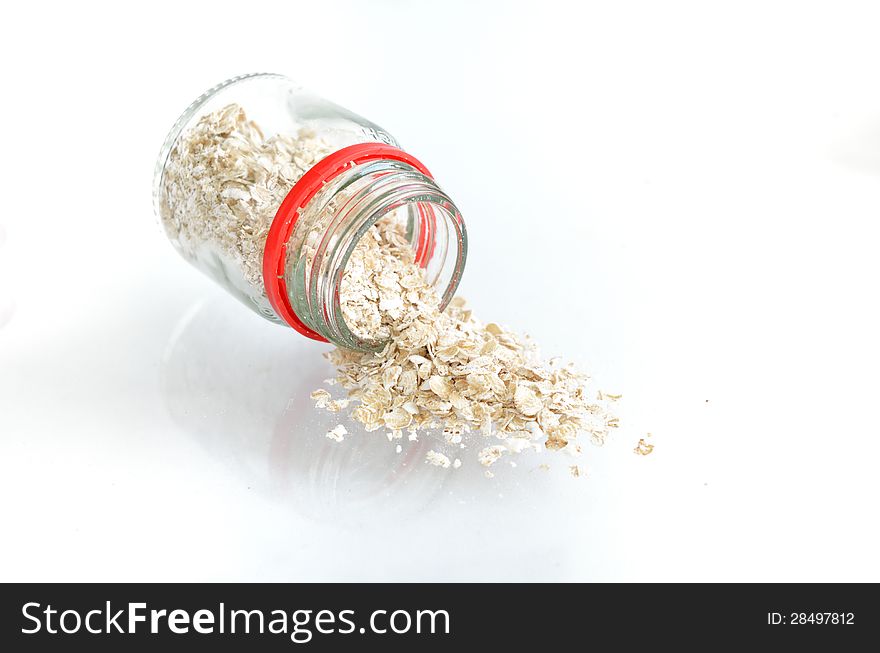 Oatmeal flakes with bottle on white background. Oatmeal flakes with bottle on white background