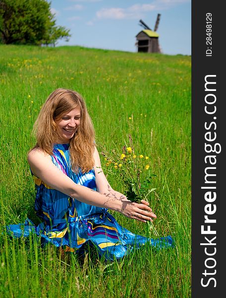 Women in field with wild flowers bouquet. Women in field with wild flowers bouquet