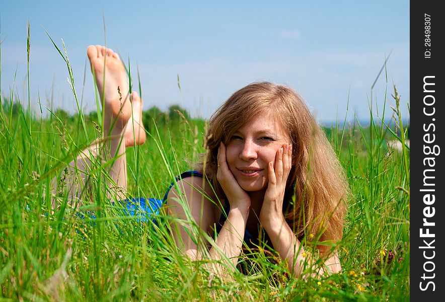 Young woman resting outdoors in meadow. Young woman resting outdoors in meadow