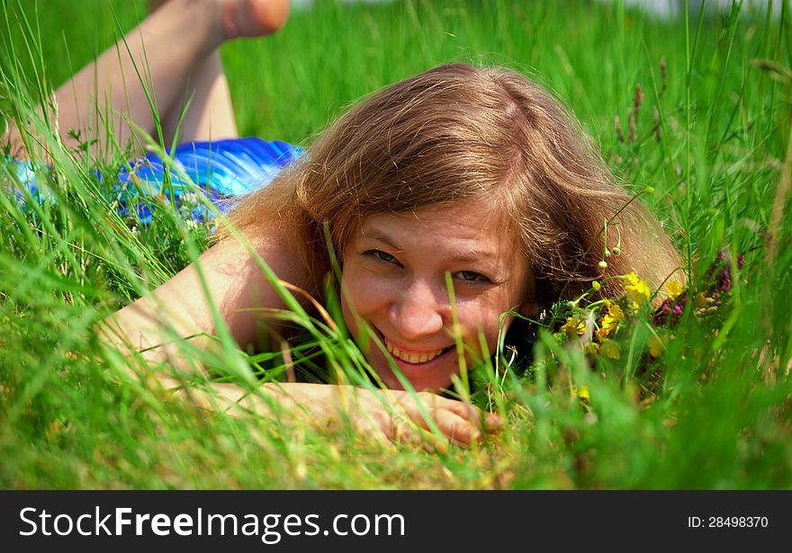 Young woman hiding in grass