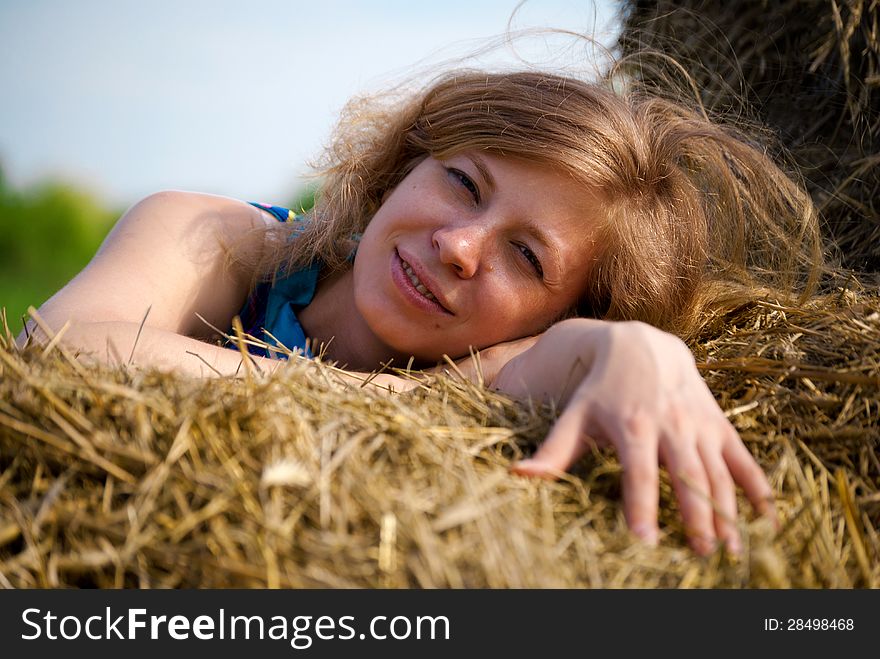 Young woman lying in straw. Young woman lying in straw