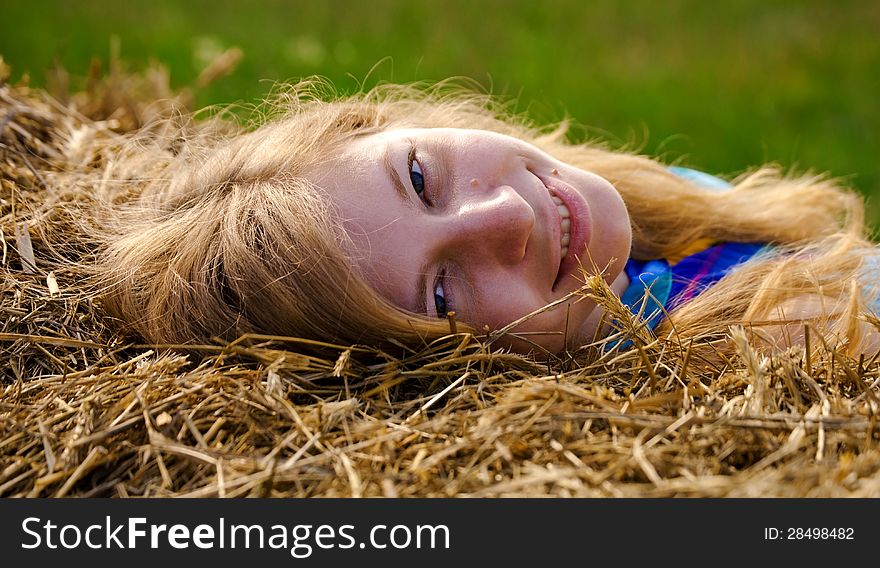 Young woman lying in straw. Young woman lying in straw