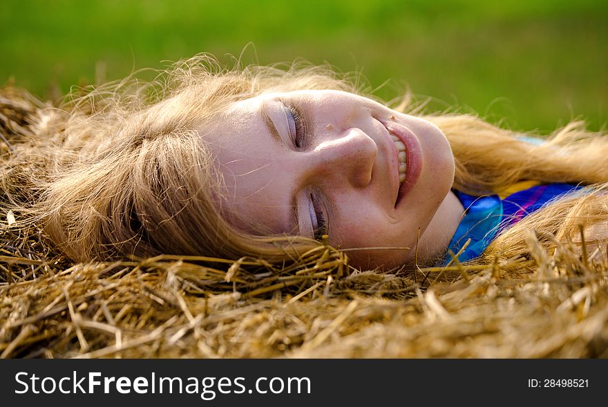 Young woman lying in straw. Young woman lying in straw