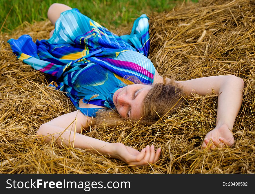 Young woman lying in straw. Young woman lying in straw