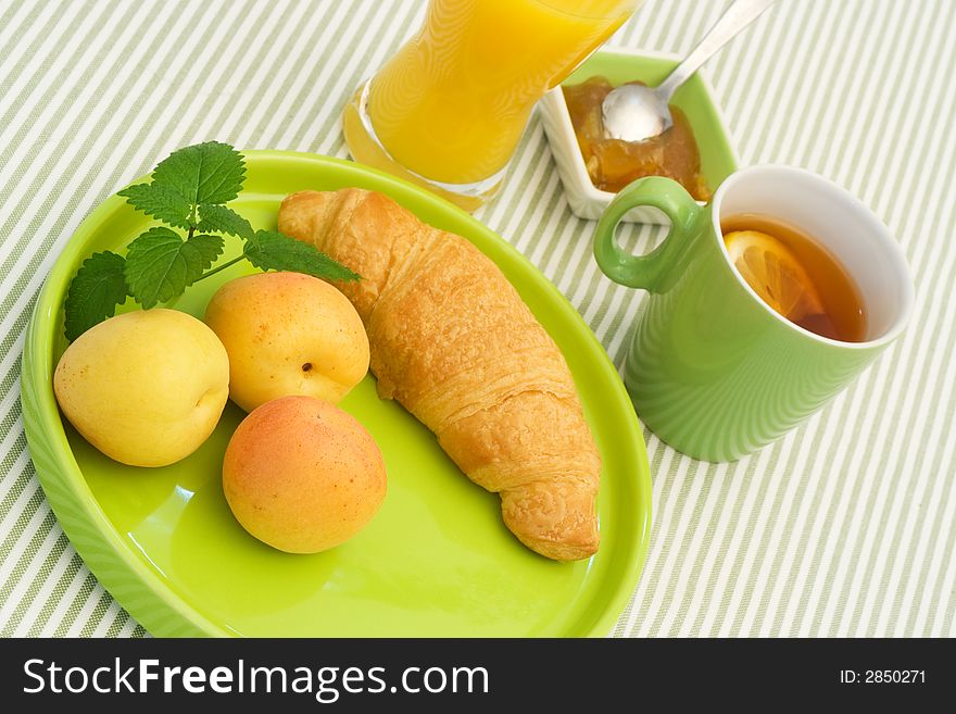 Yellow breakfast food on green tableware. Yellow breakfast food on green tableware