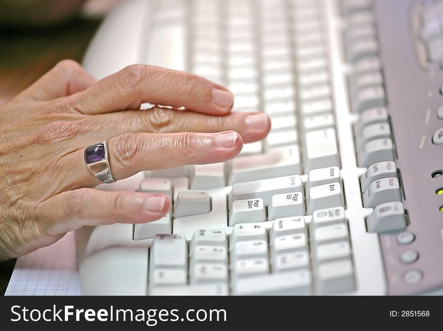 Woman's hand typing on a feyboard. Woman's hand typing on a feyboard