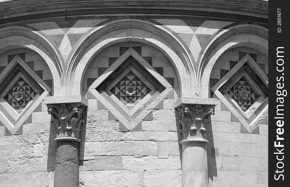 Photograph of the detail of a Romanesque style arched carving on the leaning Tower of Pisa. Photograph of the detail of a Romanesque style arched carving on the leaning Tower of Pisa