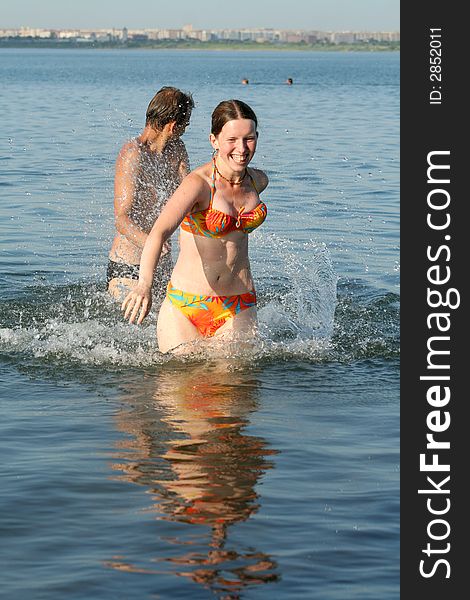 Healthy lifestyle: couple having fun in water