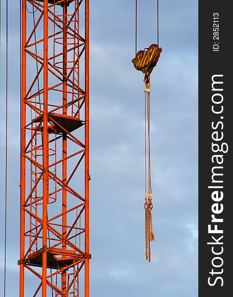 Part of the building crane with a hook and slings. Part of the building crane with a hook and slings.