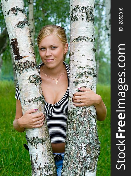 Girl about birches in the summer