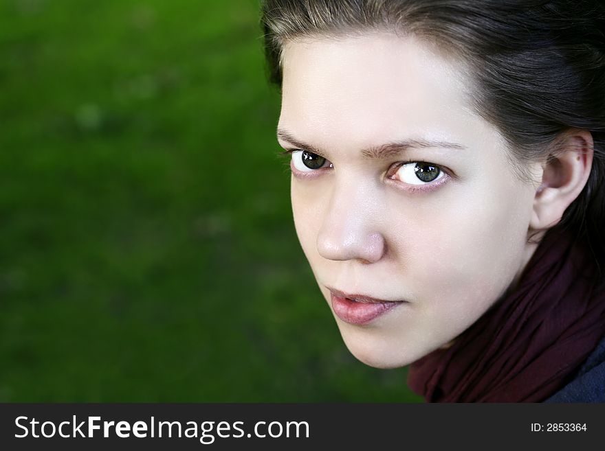 Young woman looking up, outdoor, half-profile