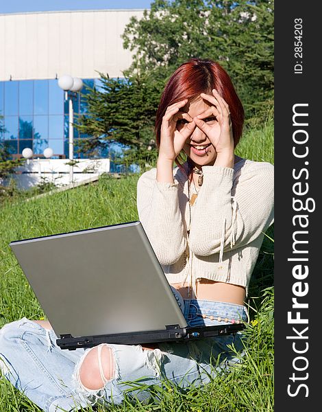 Teenager relaxing outdoors with notebook. Teenager relaxing outdoors with notebook