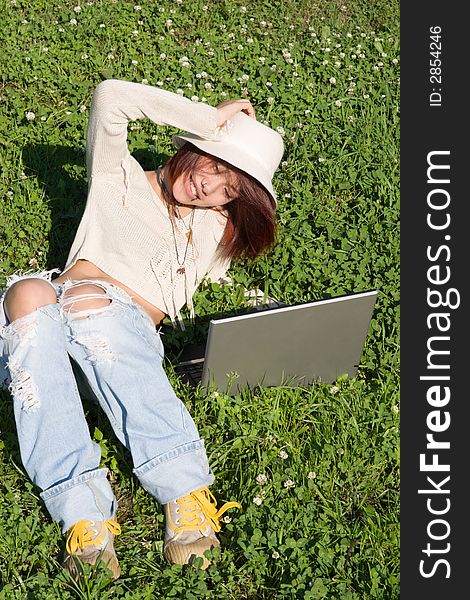 Teenager relaxing outdoors with notebook. Teenager relaxing outdoors with notebook