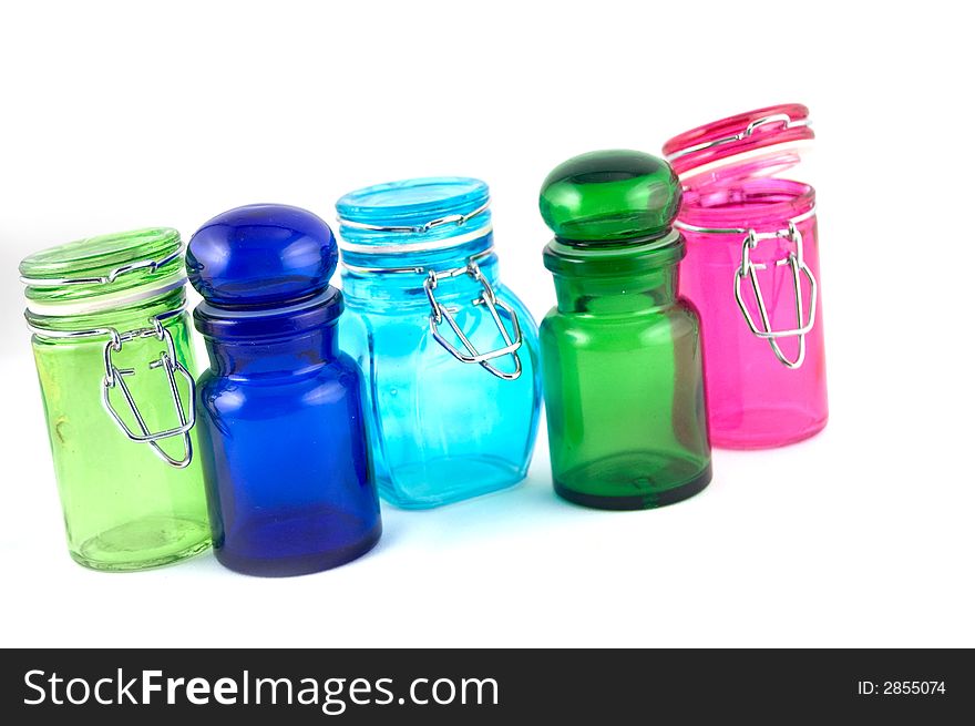 5 colourfull jars on a white background