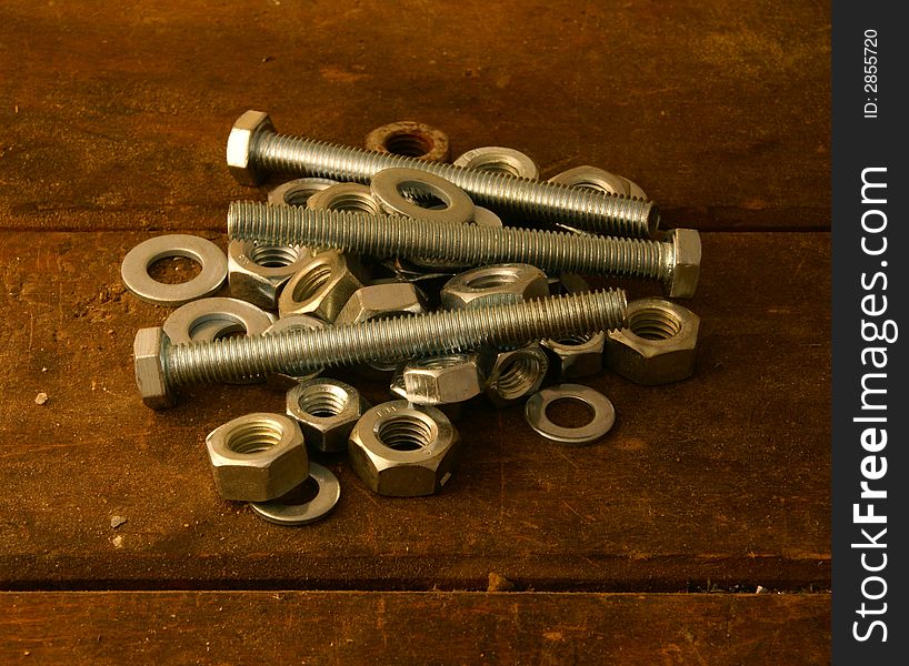 Screws, washers and female screws on worktable.