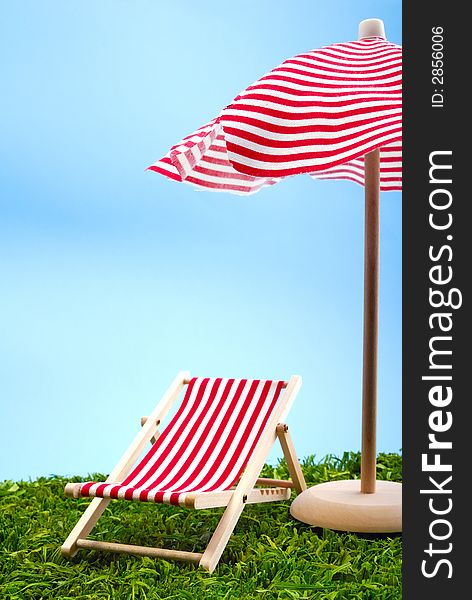 Sunshade and beach chair on the meadow. Sunshade and beach chair on the meadow