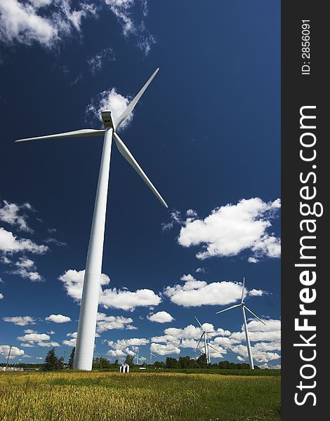 Windmills for generating electricity against a clear blue sky. Windmills for generating electricity against a clear blue sky.