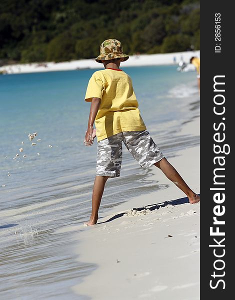 Boy at Whitehaven beach in the Whitsundays area