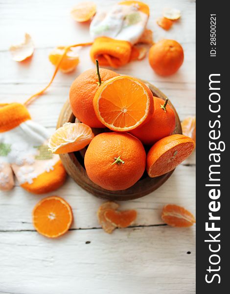 Photo of a bowl of oranges and gloves on background