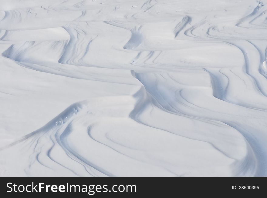 White winter snowdrift curves detail, with no sky background