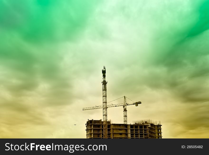 Construction site in a dusk with airplan on background