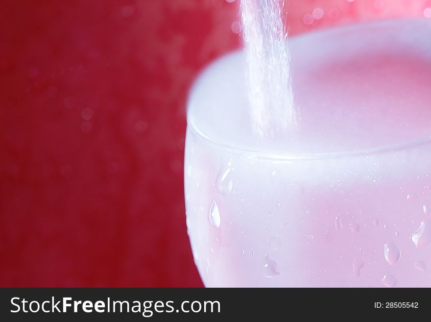 Pouring water on a red background