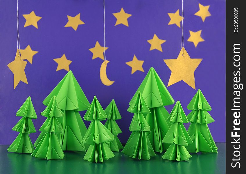 Origami composition of conifer trees with stars and moon. Origami composition of conifer trees with stars and moon