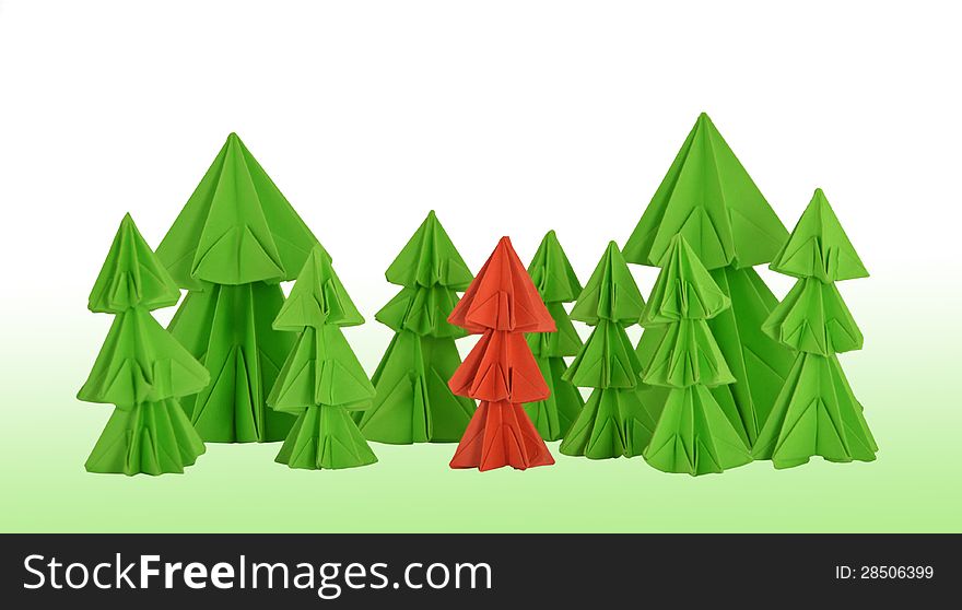 Origami composition of the red conifer among the green trees