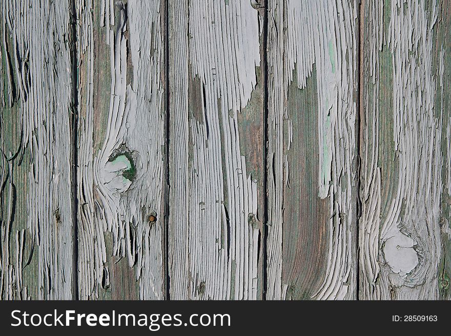 Peeling paint on weathered wood as a detailed background