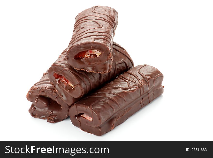 Stack of Delicious Swiss Rolls Stuffed Cream with Chocolate Glaze closeup on white background