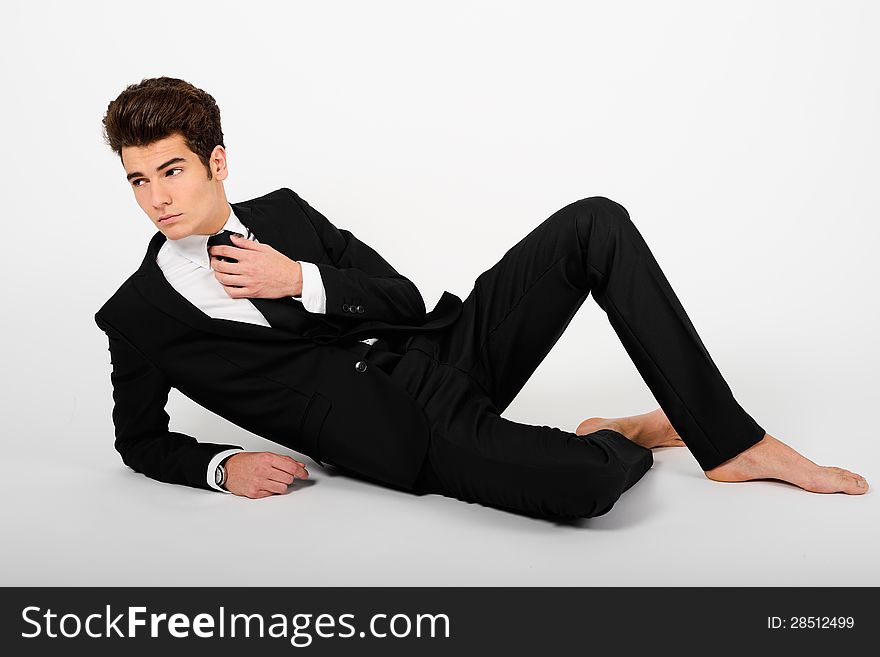 Portrait of a young businessman wearing a suit, barefoot, isolated on white background. Portrait of a young businessman wearing a suit, barefoot, isolated on white background