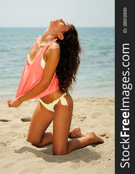 Portrait of a woman with beautiful body on a tropical beach