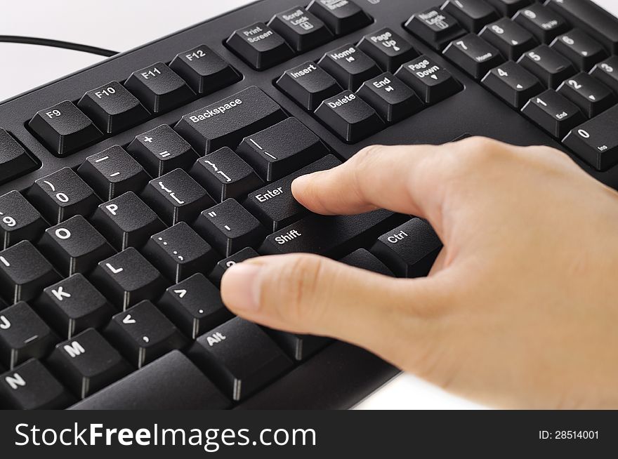 Woman hand typing on black computer keyboard over white background. Woman hand typing on black computer keyboard over white background