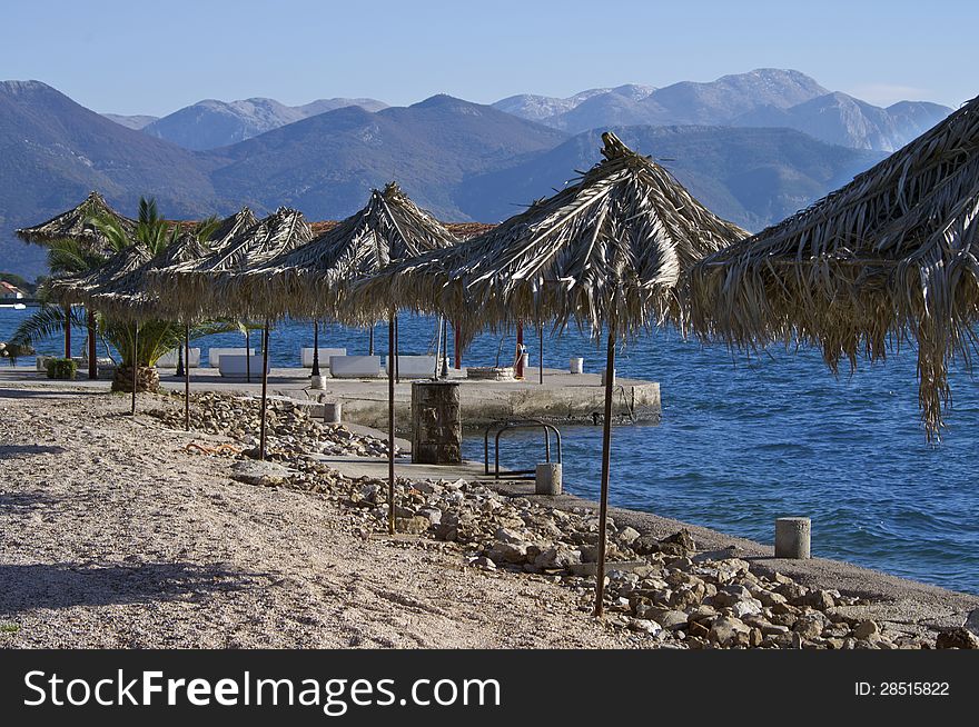 Adriatic coast of Montenegro in the winter. Blue sea and mountains in front resemble us about summer times. Adriatic coast of Montenegro in the winter. Blue sea and mountains in front resemble us about summer times.