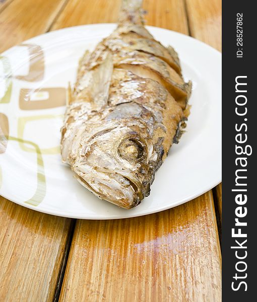 Fried fish on white dish