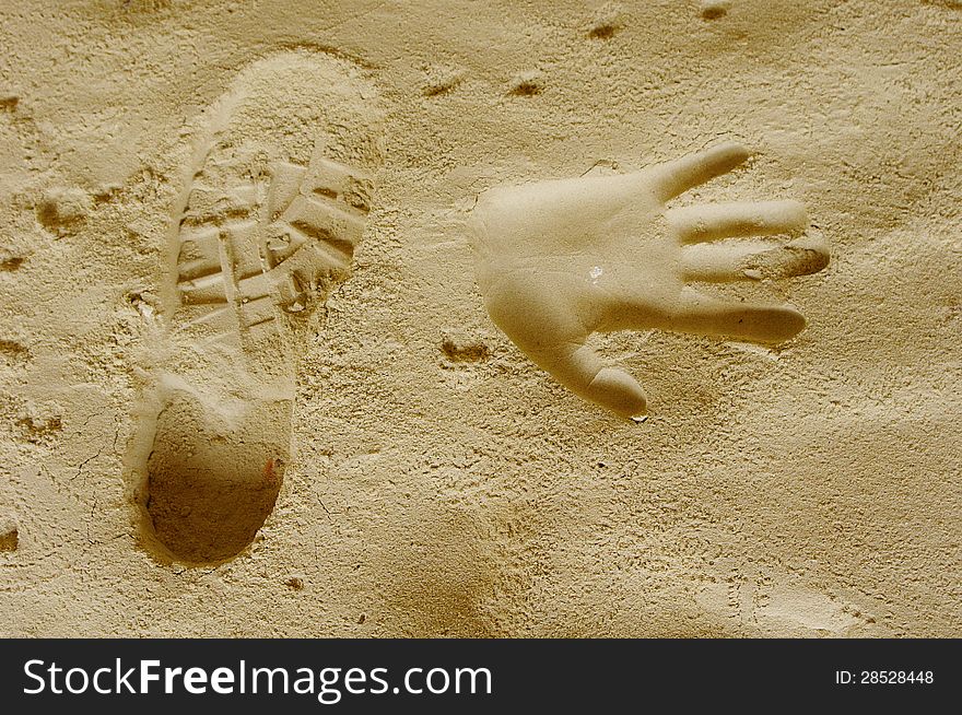 Handprints and trekking shoe print in a sand cave around Nevsha Station, Bulgaria. Handprints and trekking shoe print in a sand cave around Nevsha Station, Bulgaria