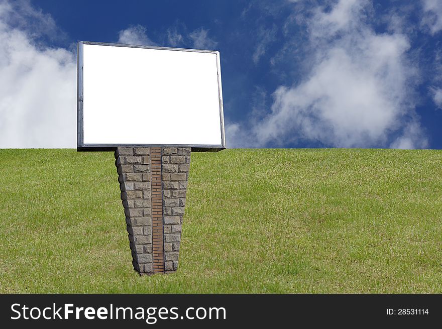 Blank signpost in the grassland over blue sky.