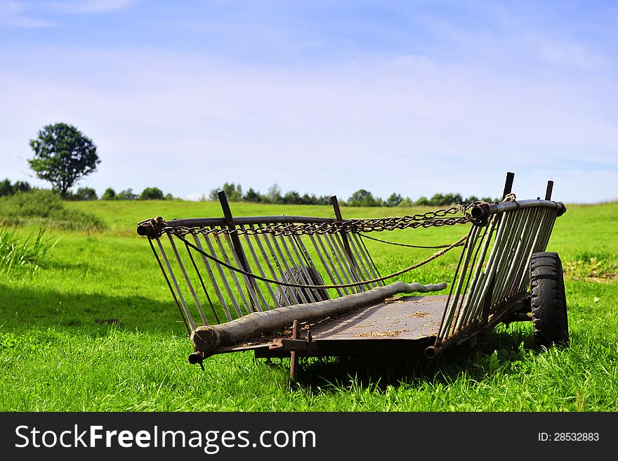 Old chariot and summer countryside