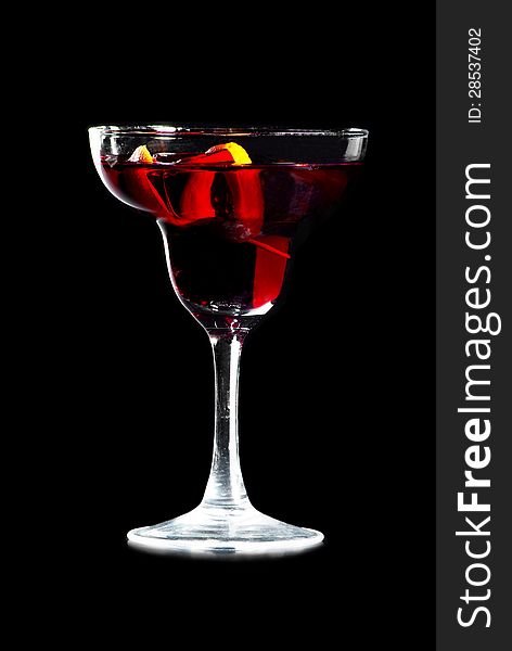 Red alcohol drink with cherry and bark of orange isolated on black. Red alcohol drink with cherry and bark of orange isolated on black
