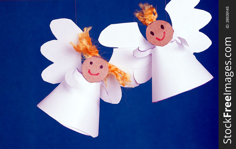 Two cheerful angels made from paper. Two cheerful angels made from paper.
