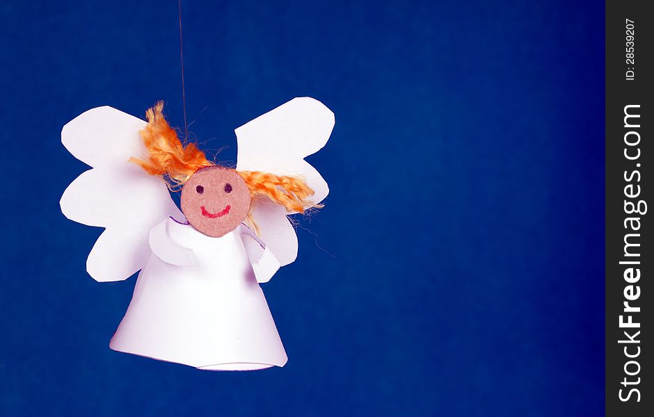 Funny paper angel girl on a blue background. Funny paper angel girl on a blue background