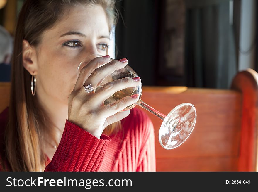 Portrait of a young woman with a glass of white wine. Portrait of a young woman with a glass of white wine.