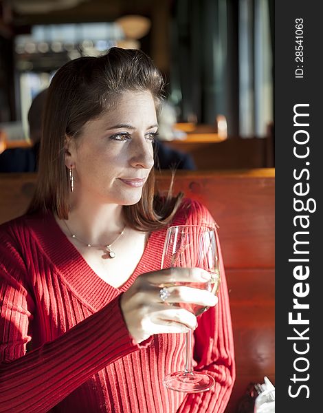 Portrait of a young woman with a glass of white wine. Portrait of a young woman with a glass of white wine.