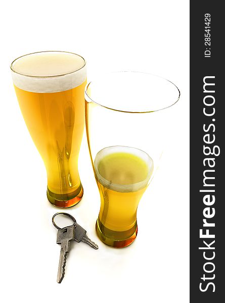 One and a half beers with car keys isolated on a white background. One and a half beers with car keys isolated on a white background