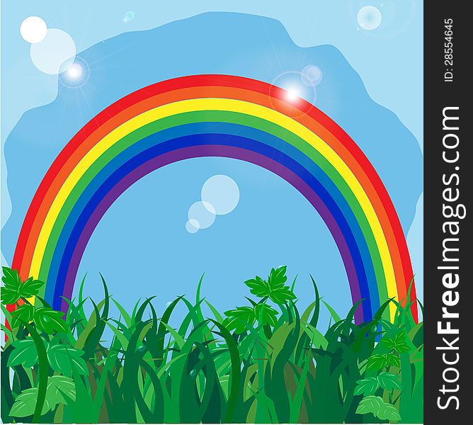 rainbow on to the meadow with a green grass on a background blue sky. rainbow on to the meadow with a green grass on a background blue sky