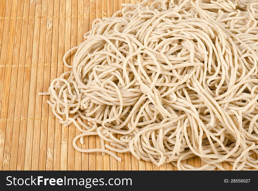 Bunch of soba noodles on a bamboo mat. Bunch of soba noodles on a bamboo mat.