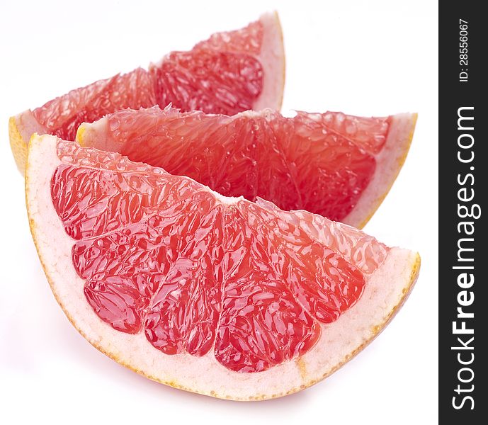 Slices of grapefruit on a white background. Slices of grapefruit on a white background.