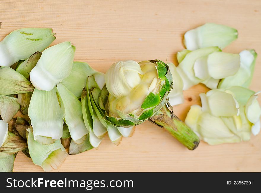 Cleaning artichoke for cooking on steam. Cleaning artichoke for cooking on steam